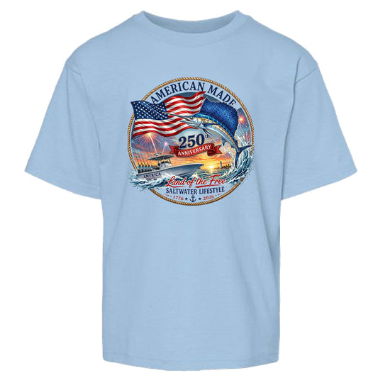 A light blue short-sleeve crewneck t-shirt featuring a circular graphic on the chest with an American flag, a jumping fish, a boat, and the text 'AMERICAN MADE', '250 ANNIIVERSARY', and 'Land of the Free SALTWATER LIFESTYLE'.