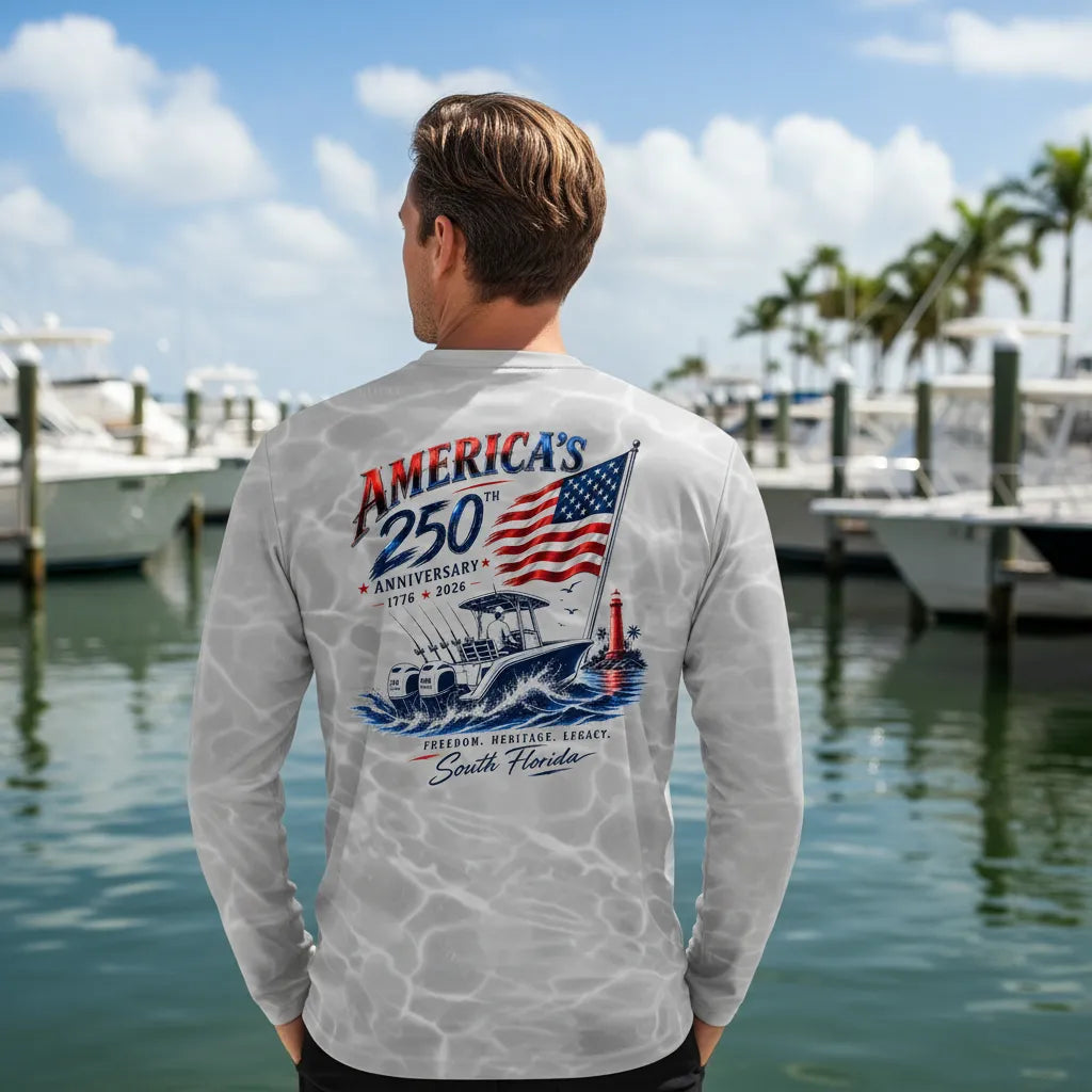 Man wearing a long-sleeve shirt with a graphic design by a marina.