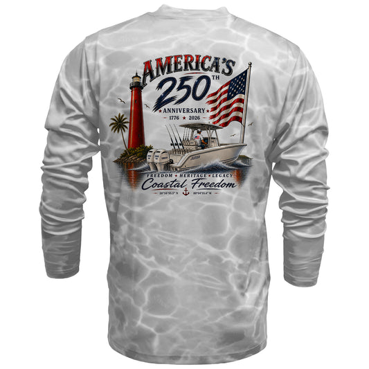 A long-sleeve white t-shirt with a gray water-ripple pattern, featuring a large graphic on the back with a lighthouse, boat, American flag, and text celebrating 'America's 250th Anniversary' and 'Coastal Freedom'.
