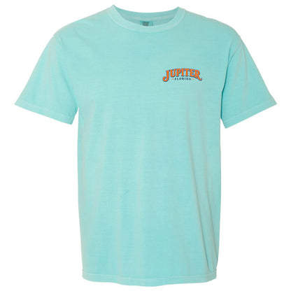 A light aqua short-sleeve crewneck t-shirt with a small orange and black 'Jupiter Florida' graphic on the left chest, displayed on a solid white background.