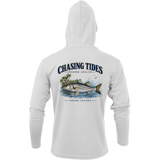 White long-sleeve hooded shirt shown from the back, featuring a large graphic print of a fish with seaweed and the text 'Chasing Tides' and 'Snook Season'.