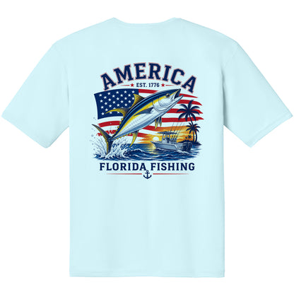 A light blue short-sleeve t-shirt with a large graphic print on the back. The graphic features a yellow tuna fish jumping in front of an American flag, with the text 'AMERICA EST.